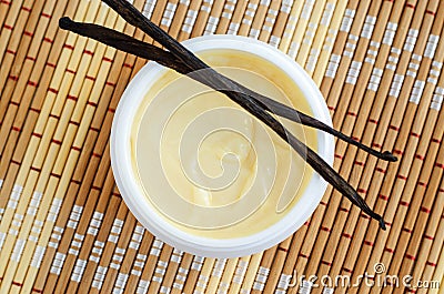 Yellow vanilla face mask banana cream, shea butter facial mask, body butter in the small white jar. Natural skin and hair care Stock Photo