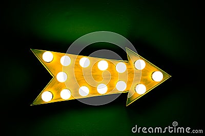 Yellow arrow: yellow vintage bright and colorful illuminated metal display arrow sign Stock Photo