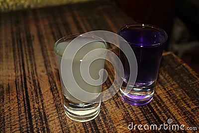 Yellow and violet shots of vodka Stock Photo