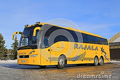 Yellow Volvo Coach Bus Parked in Winter Editorial Stock Photo