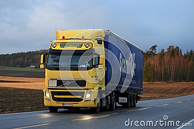 Yellow Volvo FH Transport in Evening Editorial Stock Photo
