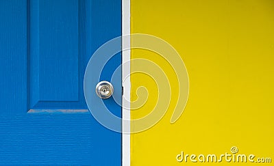 The yellow wall and close blue door for background, blue door is locked Stock Photo