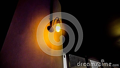 Yellow wall lamp with dark nuance and ambiance Stock Photo