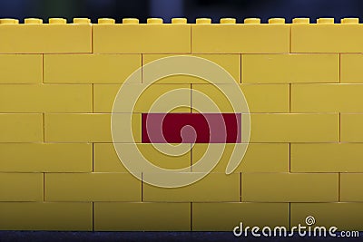 Yellow wall with toy brick Stock Photo