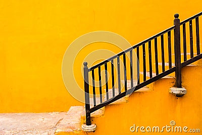 A yellow wall with stairs. Stock Photo