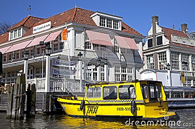 Yellow water taxi in Amsterdam, Netherlands Editorial Stock Photo