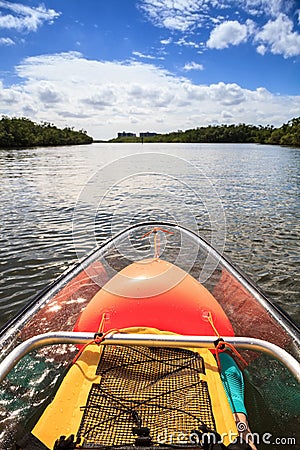 Yellow, waterproof backpack inside a Clear see-through kayak Stock Photo