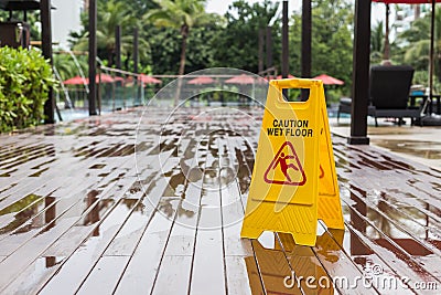 Yellow wet floor warning sign on the floor in hotel Stock Photo