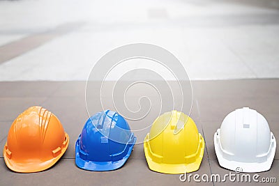 Yellow,white,blue hard safety wear helmet hat in the project at construction site Stock Photo
