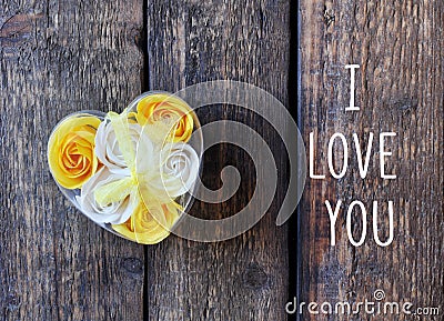 Yellow and white flowers roses in the shape of a heart. Wrapped Gift. Love Stock Photo