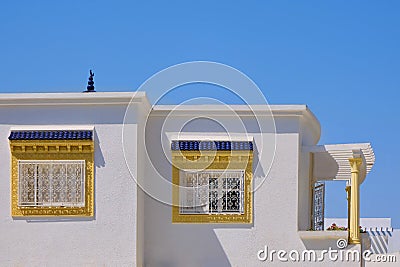 Yellow windows on a white wall arab house in Tunisia. White walls and roof Stock Photo