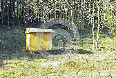 Yellow wooden bee behive for honey. Insect house. Stock Photo