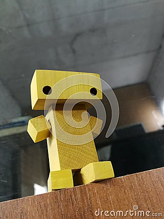 yellow wooden toy mini robot Stock Photo