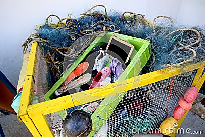 a yellow basket filled with lots of fishing gear on top of a table Stock Photo