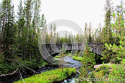 Yellowstone National Park Beautiful Bridge with rocks and moss and woodlands gorgeous colors Stock Photo