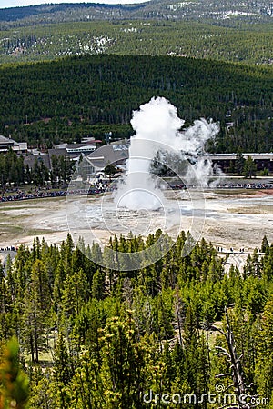 Yellowstone, Wyoming, USA, May, 25, 2021, tourists in the Upper Geyser Basin watching Old Faithful erupt Editorial Stock Photo