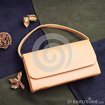 Yelloy women's clutch with a chain on a green and blue background top view Stock Photo