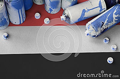 Yemen flag and few used aerosol spray cans for graffiti painting. Street art culture concept Stock Photo