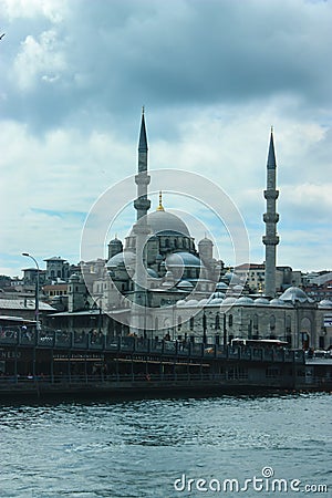 Yeni Kami Mosque in Istanbul as seen from a ferry with cloudy sk Editorial Stock Photo