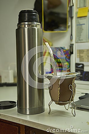 Yerba Mate infusion in a gourd with a bulb and a thermos with water Stock Photo