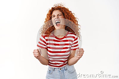 Yes finally success. Attractive curly redhead wild girl ginger hairstyle close eyes shout joyful enjoy victory winning Stock Photo