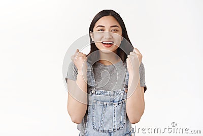 Yes gonna grab opportunity bare hands. Attractive cheerful lucky successful asian brunette girl clench fists triumphing Stock Photo