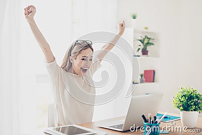 Yes! Happy excited woman at home workstation triumphing with rai Stock Photo