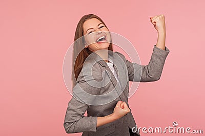 Yes I did it! Portrait of successful enthusiastic young woman in business suit screaming for joy with raised fists Stock Photo