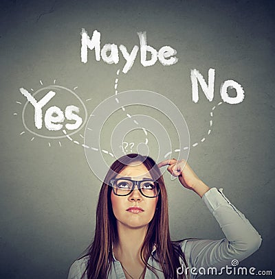 Yes Maybe or No? Thoughtful woman making a choice Stock Photo