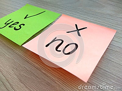 Yes or no question message on sticky notes with focus on no on wooden background. Rejection and failure concept Stock Photo