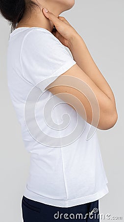 Ying girl`s hand grabbed her neck because of a medical concept pain. Stock Photo