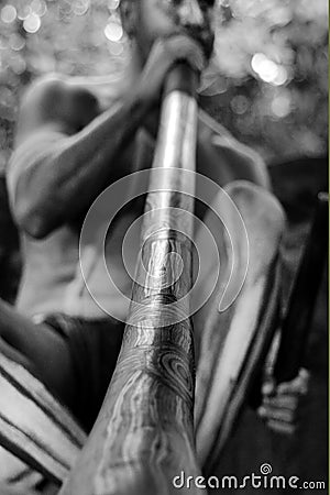 Yirrganydji Aboriginal man play Aboriginal music on didgeridoo Stock Photo