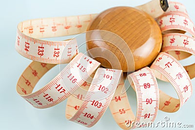 Yo-yo effect concept. Wooden yoyo with centimeter measure Stock Photo