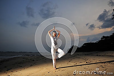 Yoga By The Beach Stock Photo