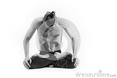 Yoga. Black and white Portrait of yogi men doing yoga exercise, he breath and performing Upward abdominal lock. Young men workout Stock Photo