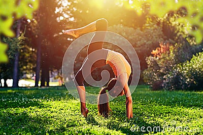 Yoga. Bridge exercise. Young woman practicing yoga or dancing or stretching in nature at park. Health lifestyle concept Stock Photo