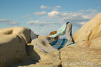 Yoga. Children yoga. Sports training for children in nature. Sea and sport. White stones on the shore. Cute kid on sea Stock Photo