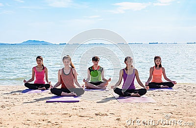 Yoga class at sea beach in sunny day ,Group of people doing lotus pose with relax emotion,Meditation pose,Wellness and Stock Photo