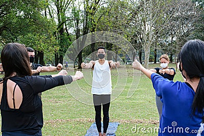 Sao Paulo, Sao Paulo, Brazil. July, 04 2021. 28 year old Brazilian young man giving yoga class on a sunny day in the public park Editorial Stock Photo