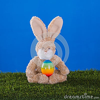 Yoga concept.Teddy rabbit playing sports with him Easter egg. Stock Photo