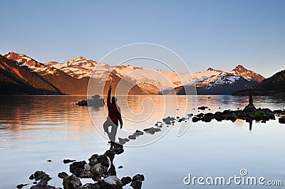 Yoga Girl balancing on rock Stock Photo