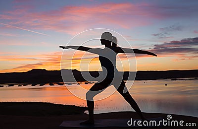 Yoga Girl by the Lake at Sunrise Stock Photo