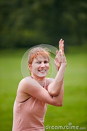 Yoga - good for the body, great for the mind. a woman practicing yoga in a park. Stock Photo