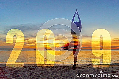 Yoga Happy new year card 2019. Silhouette lifestyle woman practicing yoga standing as part of Number 2019 near the beach at sunset Stock Photo