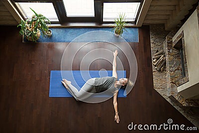 Yoga at home: Belly Twist Pose Stock Photo