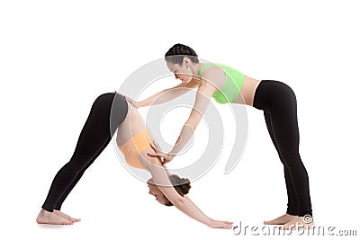 Yoga instructor assists student Stock Photo