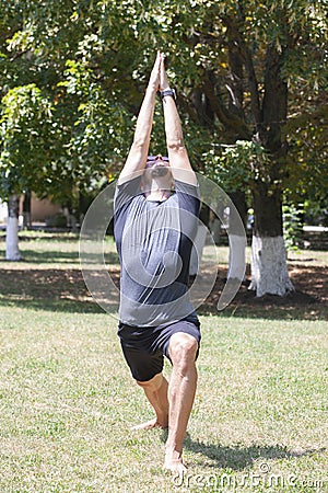 Yoga man meditating at sunset. Male model of meditation in serene harmony Stock Photo