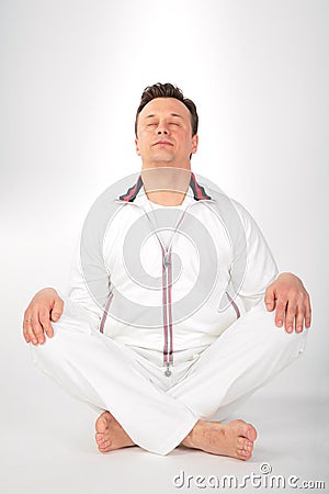 Yoga man in white sportswear Stock Photo