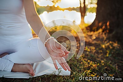 Hand of a young woman are folded in a special way into a yoga m Stock Photo