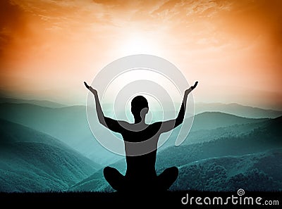 Yoga and meditation. Silhouette of man on the mountain. Stock Photo